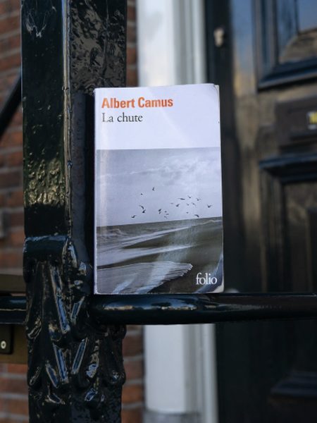 La Chute d’Albert Camus, posé sur une grille en fer forgé noir